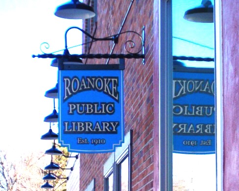 A photo of Sign hanging outside the library 
